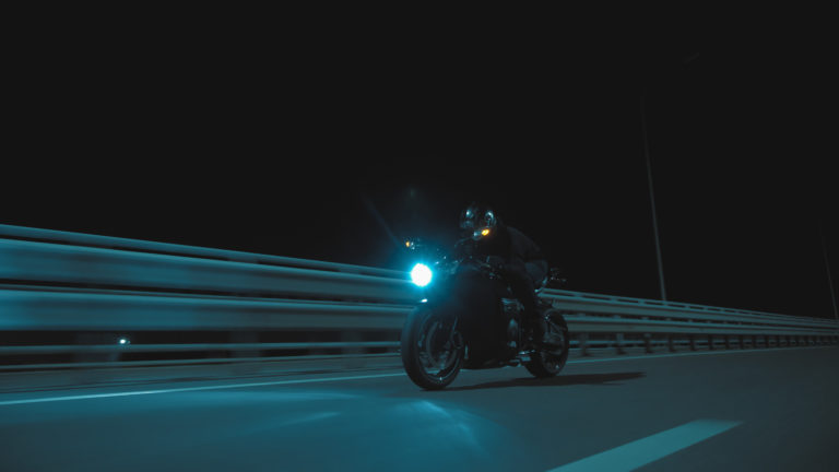 a man rides a sports motorcycle on a night track